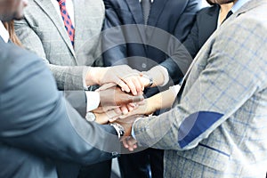 Businessman team in suit touching hands together. Selective focus.