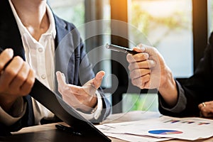 Businessman team working at office desk and using a digital comp