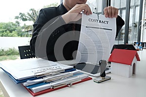 Businessman tearing agreement document. breaking contract