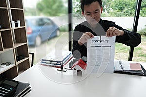 Businessman tearing agreement document. breaking contract