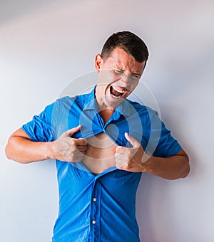 Businessman tearing off his shirt and showing mucular body concept on background