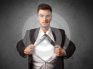 Businessman tearing off his shirt with white copyspace on chest