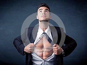 Businessman tearing off shirt and showing mucular body