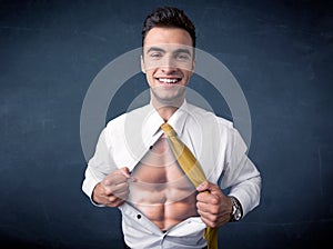 Businessman tearing off shirt and showing mucular body