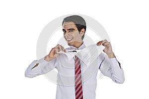 Businessman tearing a paper