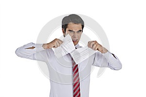 Businessman tearing a paper