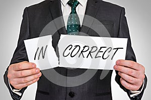 Businessman tearing paper with incorrect word