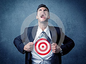 Businessman tearing shirt with target sign on his chest