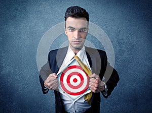 Businessman tearing shirt with target sign on his chest