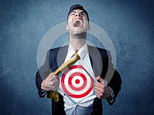 Businessman tearing shirt with target sign on his chest
