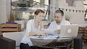 Businessman tearing up a document, contract or agreement on business meeting in cafe