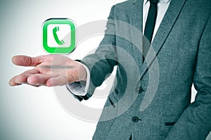 Businessman with a telephone icon in his hand