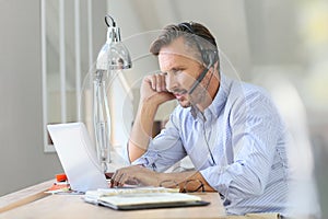 Businessman teleworking on laptop