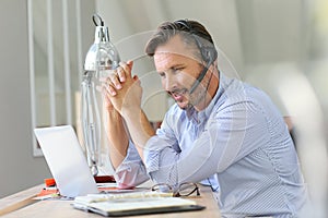 Businessman teleworking on laptop