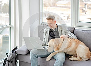 Businessman teleworking next to dog