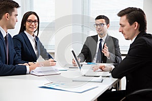 Businessman tells his colleagues about a new project photo