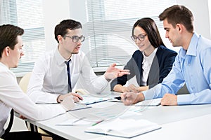 Businessman tells his colleagues about a new project photo