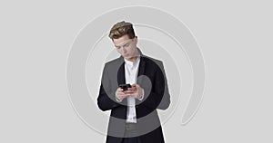 Businessman text messaging on mobile phone