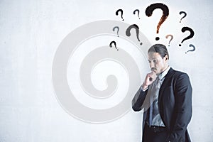Businessman thinking with drawing question mark