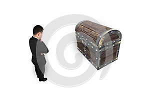 Businessman thinking and looking at old treasure chest