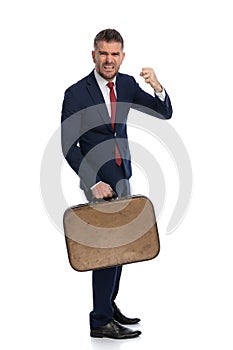 Businessman threatening with his fist raised and being very aggressive