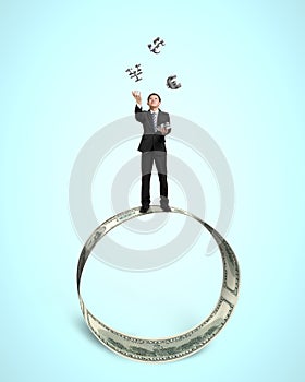 Businessman throwing and catching 3D money symbols on money circle