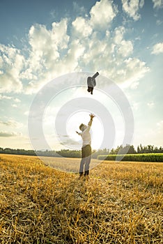 Businessman Throwing Coat in the Air at the Field