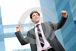 Businessman throwing paper airplane