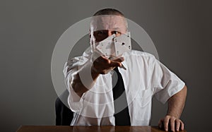 Businessman throwing playing cards.