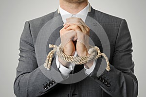 Businessman with tied hands