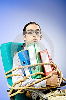 Businessman tied with rope