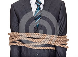 Businessman tied up in rope photo