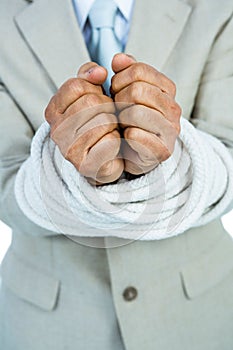 Businessman tied up in rope