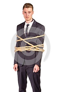 Businessman tied up in rope.
