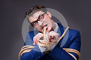 The businessman tied up with rope