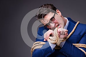 The businessman tied up with rope