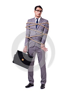 The businessman tied up with rope isolated on white