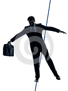 Businessman tightrope walker silhouette