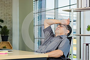 Businessman tired overworked he relaxing with closed eyes