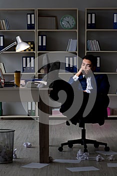 Businessman tired and sleeping in the office after overtime hour