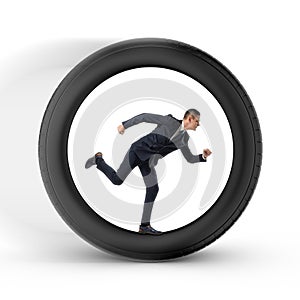 Businessman to be pressed for time is running in the center of a big wheel