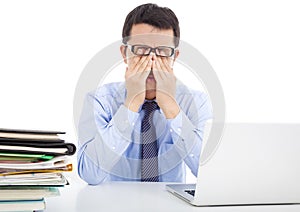 Businessman is too fatigued to rubbing his eyes