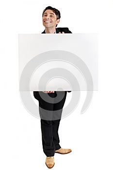 Businessman with a toothy grin with a blank sign