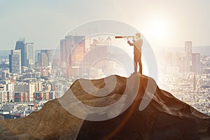 Businessman at the top of mountain in career concept