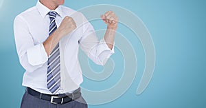 Businessman Torso with combative posture against neutral blue background