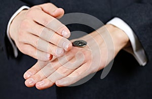 Businessman tossing a coin. Heads or tails. Close up