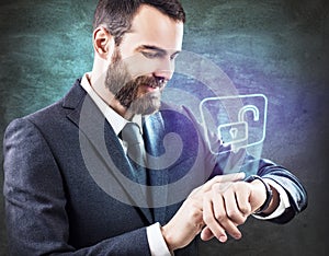 Businessman touches virtual icon from smartwatch.