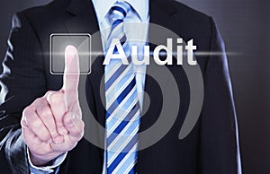 Businessman touching audit button