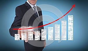 Businessman touching a chart with a red arrow pointing up