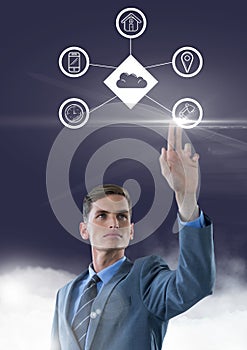 Businessman touching connecting icons against clouds